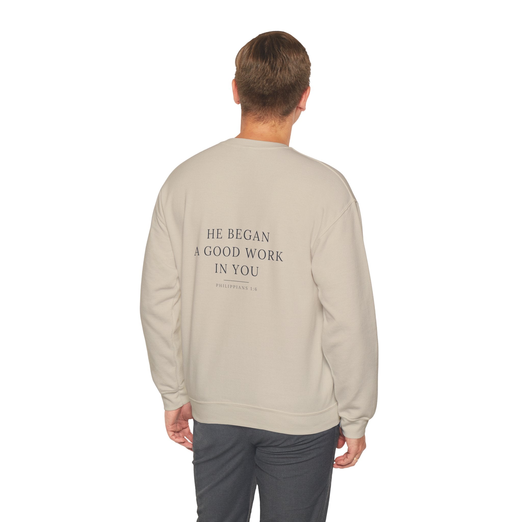 He Began A Good Work crewneck — Philippians 1:6 scripture across the back, heartbeat-cross at the chest. Hallowed Supply Co.