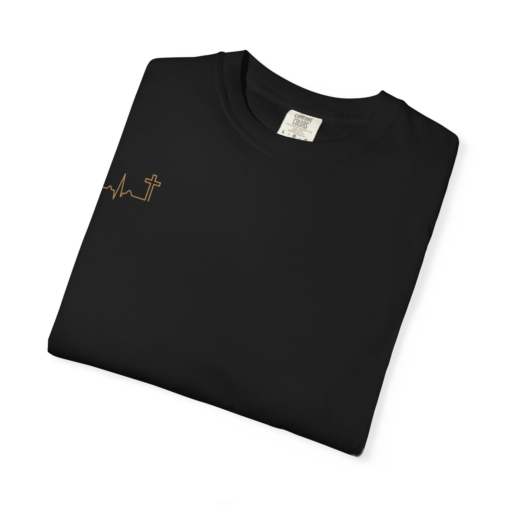 Heartbeat Cross gold tee — antique-gold heartbeat-cross over the heart on a dark garment-dyed tee. Hallowed Supply Co.