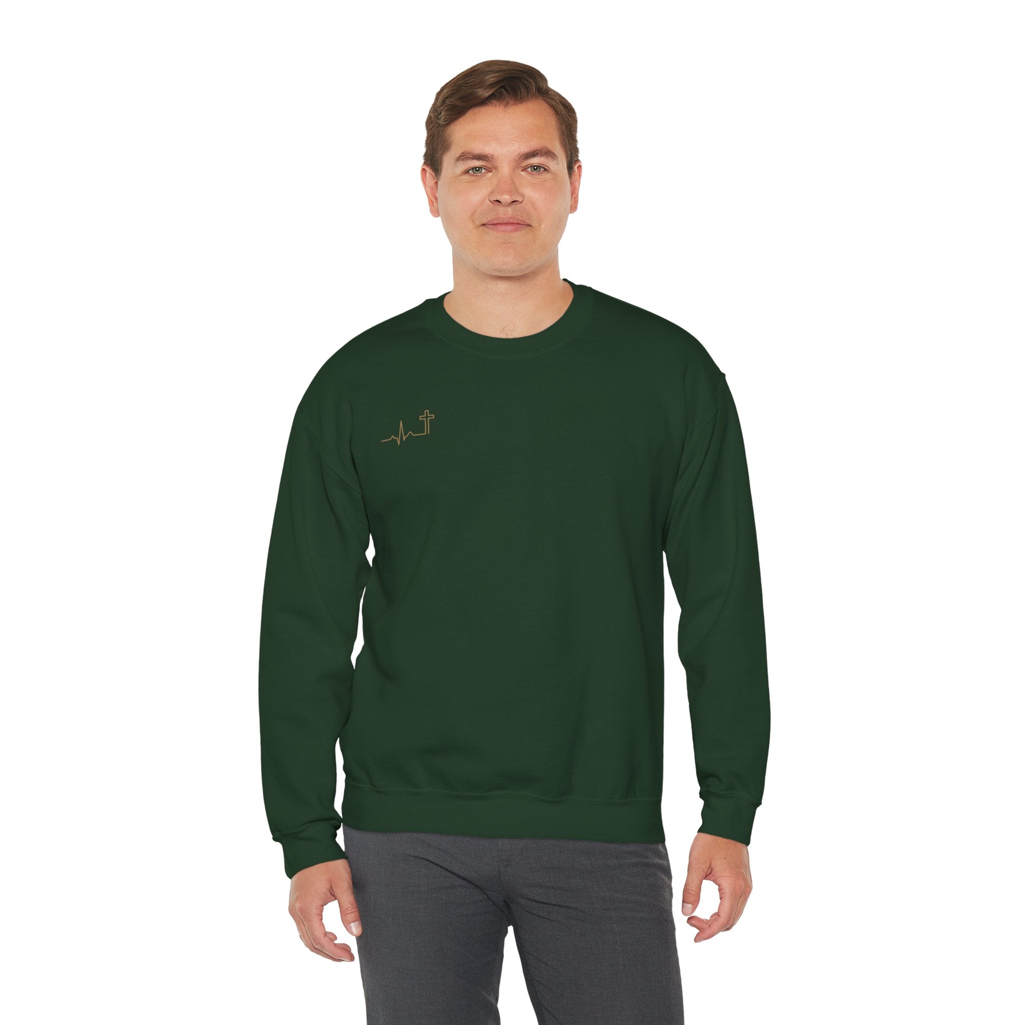Heartbeat Cross gold crewneck — antique-gold heartbeat-cross over the heart on a dark crewneck sweatshirt. Hallowed Supply Co.